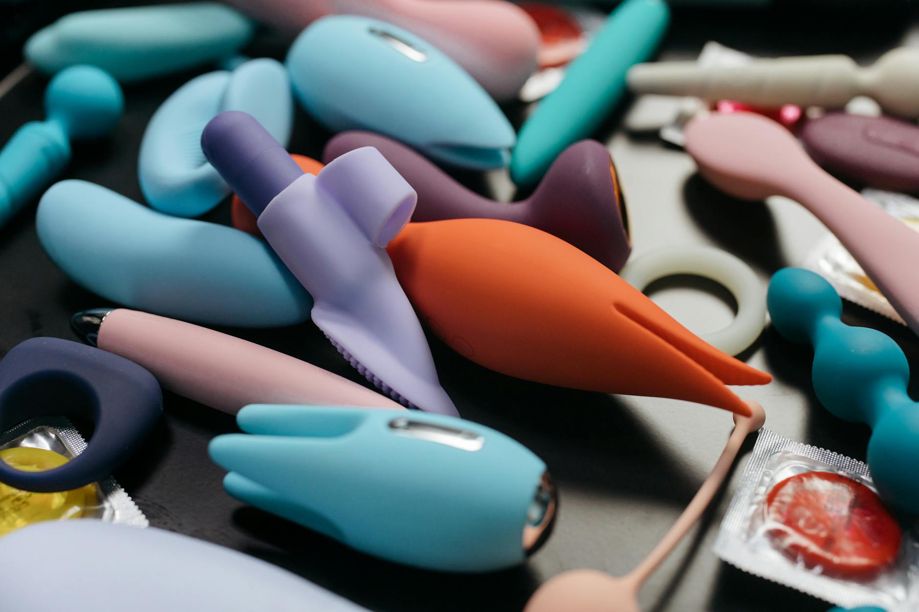 An array of vibrant clitoral vibrators and pleasure toys displayed in close-up.
